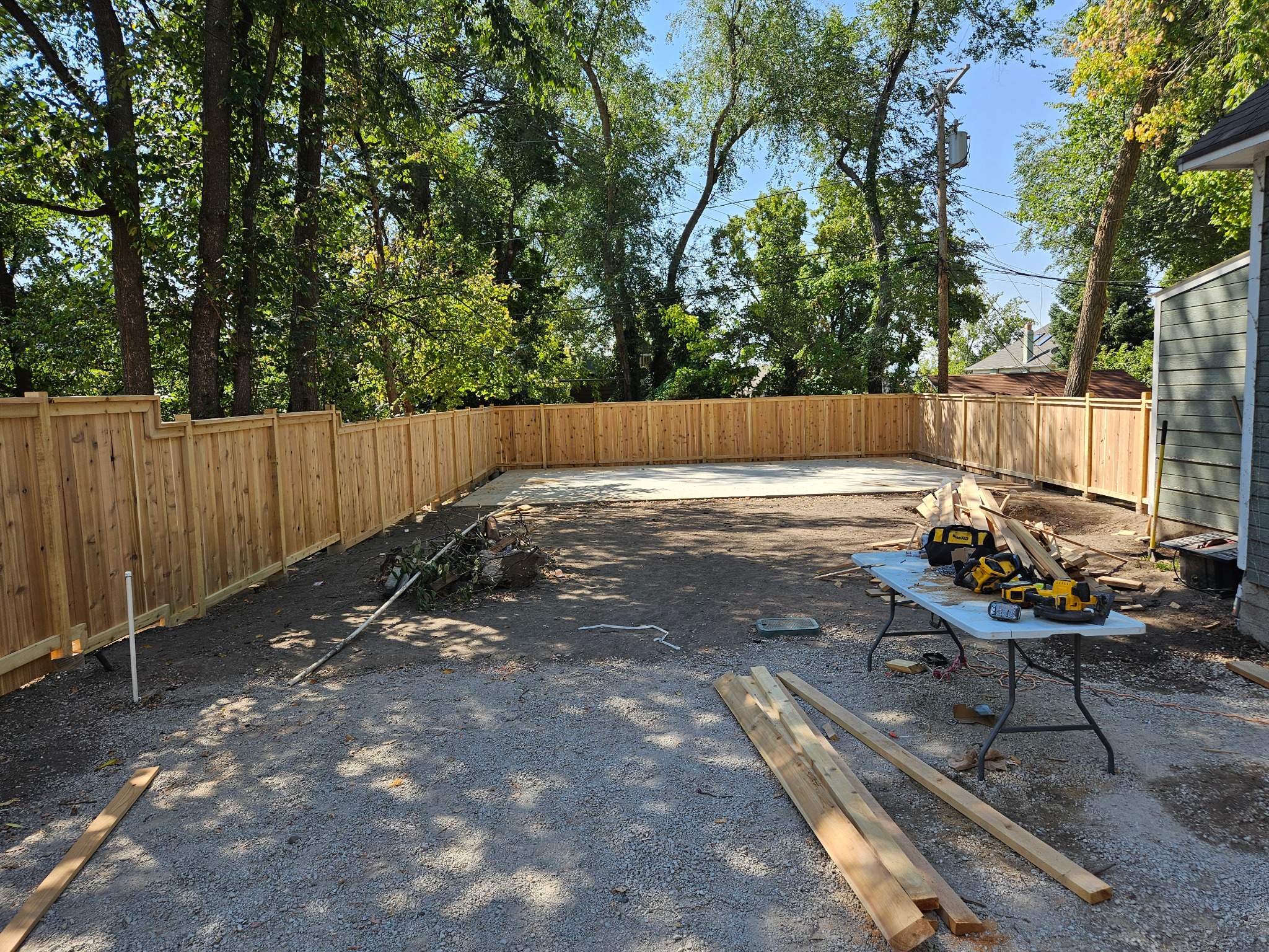 New custom wood privacy fence installed around a residential backyard