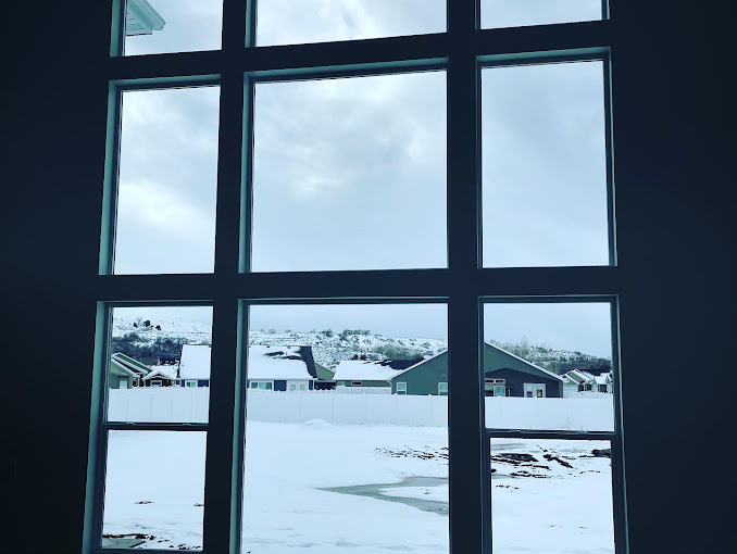 Large clean window wall overlooking a snowy Northern Utah neighborhood